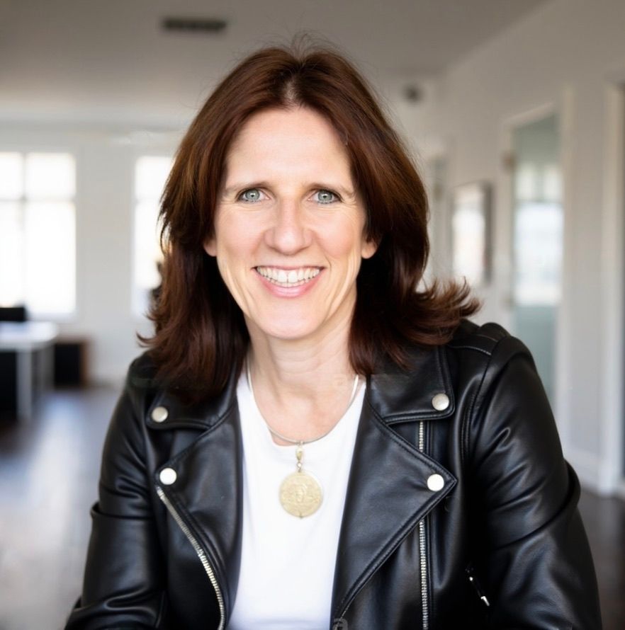 Claudia Beck smiling, in a black leather jacket
