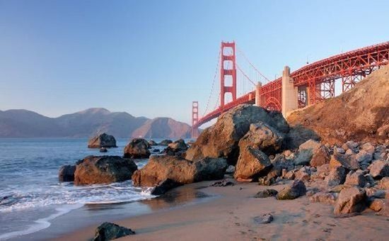 The Golden Gate Bridge seen from the rocks of a beach below it